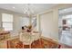 Formal dining room featuring a chandelier, window, and decorative rug at 7216 Campolina Ct, Las Vegas, NV 89113