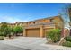 Beautiful two-story home with a three-car garage, terracotta tile roof, and desert landscaping at 7216 Campolina Ct, Las Vegas, NV 89113