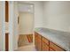 Hallway with cabinets and light-colored granite countertop leads to carpeted area at 7216 Campolina Ct, Las Vegas, NV 89113