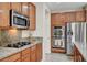 Kitchen with granite counters, stainless steel appliances, cooktop and double oven at 7216 Campolina Ct, Las Vegas, NV 89113