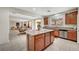 Open kitchen with granite countertops, stainless appliances, island, and breakfast nook at 7216 Campolina Ct, Las Vegas, NV 89113