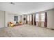 Spacious living room with neutral carpet, large windows, and natural light at 7216 Campolina Ct, Las Vegas, NV 89113