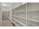 Walk-in pantry with tiled floor and rows of white shelves for ample storage at 7216 Campolina Ct, Las Vegas, NV 89113