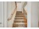 Carpeted staircase with wooden handrail and decorative iron balusters at 7216 Campolina Ct, Las Vegas, NV 89113