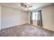 Bedroom with neutral walls, carpet, ceiling fan, and natural light from the window at 7477 Onyx Star St, North Las Vegas, NV 89084