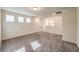 Bright bonus room with gray carpet and natural light from three windows at 7477 Onyx Star St, North Las Vegas, NV 89084