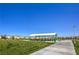 Community park featuring picnic tables, a covered pavilion, playground, and green space at 7477 Onyx Star St, North Las Vegas, NV 89084