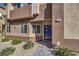 Stylish home with a blue front door, complemented by desert landscaping and a paver walkway at 7477 Onyx Star St, North Las Vegas, NV 89084