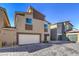 Exterior of a townhome featuring a two car garage and a modern stucco facade at 7477 Onyx Star St, North Las Vegas, NV 89084