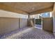 Covered patio featuring a paver floor, privacy fencing, and a gate leading to a backyard area at 7477 Onyx Star St, North Las Vegas, NV 89084