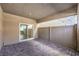 Covered patio featuring a paver floor, privacy fencing, and a sliding glass door leading to the interior at 7477 Onyx Star St, North Las Vegas, NV 89084