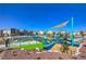 Community playground with colorful equipment and shade structures in a well-maintained neighborhood at 7477 Onyx Star St, North Las Vegas, NV 89084