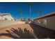 Fenced in backyard featuring mature palm trees and low maintenance landscaping at 7695 Silver Wells Rd, Las Vegas, NV 89149
