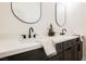 Stylish bathroom features dark cabinets, a white countertop, dual sinks, and black plumbing fixtures at 7695 Silver Wells Rd, Las Vegas, NV 89149