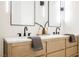 Bathroom vanity featuring dual sinks, modern fixtures, and neutral color palette at 7695 Silver Wells Rd, Las Vegas, NV 89149