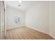 Empty bedroom with wood floors and white walls, with one window to let in natural light at 7695 Silver Wells Rd, Las Vegas, NV 89149