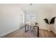Bright and empty bedroom space featuring modern wood floors, a writing desk, and a white closet at 7695 Silver Wells Rd, Las Vegas, NV 89149