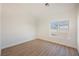 An empty bedroom featuring wood floors, a single window, and bright white walls, waiting for personalization at 7695 Silver Wells Rd, Las Vegas, NV 89149