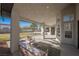 Rear covered patio with comfortable seating area and views of pool and lush landscaping at 7695 Silver Wells Rd, Las Vegas, NV 89149