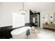 Modern bathroom featuring soaking tub, glass shower, and dual vanities at 7695 Silver Wells Rd, Las Vegas, NV 89149