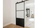 Modern bathroom with tile floors, glass enclosed shower, and black paneled doors at 7695 Silver Wells Rd, Las Vegas, NV 89149
