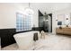 Luxurious bathroom featuring soaking tub, glass shower, and dual vanities at 7695 Silver Wells Rd, Las Vegas, NV 89149