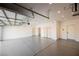 Spacious garage with epoxy floors, multiple storage closets, and overhead lighting at 7695 Silver Wells Rd, Las Vegas, NV 89149