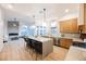 Open-concept kitchen with a large island, stainless steel appliances, and a cozy living area at 7695 Silver Wells Rd, Las Vegas, NV 89149