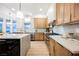 Spacious kitchen featuring stainless steel appliances, lots of cabinets, an island and a big window at 7695 Silver Wells Rd, Las Vegas, NV 89149