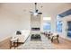 Bright living room with a modern fireplace, vaulted ceiling, and large windows at 7695 Silver Wells Rd, Las Vegas, NV 89149