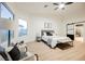 Bright main bedroom with ceiling fan, sitting area, and ensuite bathroom at 7695 Silver Wells Rd, Las Vegas, NV 89149