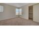 Carpeted bedroom with a corner window and closet with sliding doors, providing ample storage at 8329 Telescope Peak Ct, Las Vegas, NV 89145