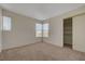 This bedroom features neutral carpeting, a closet with sliding doors, and natural light from two windows at 8329 Telescope Peak Ct, Las Vegas, NV 89145