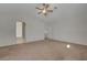 Bright bedroom featuring vaulted ceilings, a ceiling fan, carpet, and an adjoining bathroom at 8329 Telescope Peak Ct, Las Vegas, NV 89145
