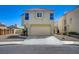 Two-story home features a two-car garage and low maintenance landscaping at 8329 Telescope Peak Ct, Las Vegas, NV 89145