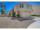 Stucco two-story home has desert landscaping and a two-car garage at 8329 Telescope Peak Ct, Las Vegas, NV 89145