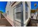 Narrow side yard featuring a chainlink gate, and view of the home's exterior wall at 8329 Telescope Peak Ct, Las Vegas, NV 89145