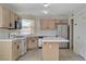 Cozy kitchen with center island and stainless steel refrigerator at 8329 Telescope Peak Ct, Las Vegas, NV 89145