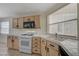 Bright kitchen features stainless steel appliances and tile counters at 8329 Telescope Peak Ct, Las Vegas, NV 89145