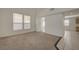 Bright living room with carpet and tile flooring leading to other rooms at 8329 Telescope Peak Ct, Las Vegas, NV 89145