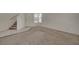 Spacious living room with carpet flooring near the entryway and stairs at 8329 Telescope Peak Ct, Las Vegas, NV 89145