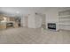 Open-concept living space has a fireplace, kitchen, and tile flooring at 8329 Telescope Peak Ct, Las Vegas, NV 89145
