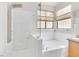Spa-like bathroom featuring a soaking tub, frameless shower, and modern fixtures at 8912 Galena Crossing St, Las Vegas, NV 89123