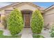 Close up view of a home's front door surrounded by manicured landscaping and decorative shrubbery at 8912 Galena Crossing St, Las Vegas, NV 89123