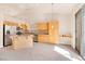 Open kitchen features stainless steel appliances, center island, and tile flooring at 8912 Galena Crossing St, Las Vegas, NV 89123