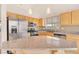 Bright kitchen boasts stainless appliances, granite counters, and ample cabinet space at 8912 Galena Crossing St, Las Vegas, NV 89123