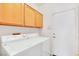 Laundry room with modern washer and dryer and cabinets at 8912 Galena Crossing St, Las Vegas, NV 89123
