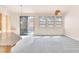 Open living room with light filled windows adjacent to kitchen and backyard access at 8912 Galena Crossing St, Las Vegas, NV 89123