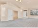 Bright living room with neutral carpet, a high ceiling, and large windows, offering lots of natural light at 8912 Galena Crossing St, Las Vegas, NV 89123