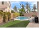 Backyard featuring a private pool, lush greenery, and a well-maintained lawn, ideal for relaxation at 8912 Galena Crossing St, Las Vegas, NV 89123